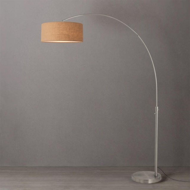 The Float Arc Lamp is a modern arc lamp designed by Peter Morelli in 1960, featuring a satin nickel steel frame and a...