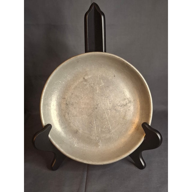 This exceptional, museum-grade piece of early 18th-century European metalware is a shallow pewter bowl (or deep...