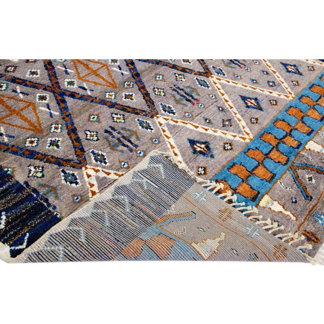 Beautiful modern Moroccan style hand-knotted wool rug with a gray and brown field. This piece has multicolor accent color...