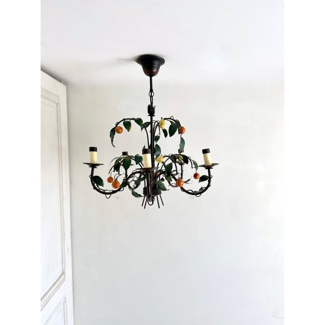 French five-light tole chandelier by J.P. Ryckaert, circa 1985–1995, with green leaves, lemons, and tangerines on a dark...