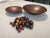 This set of bowls and wooden pebbles is a stunning display of craftsmanship. The bowls are made from copper while the...