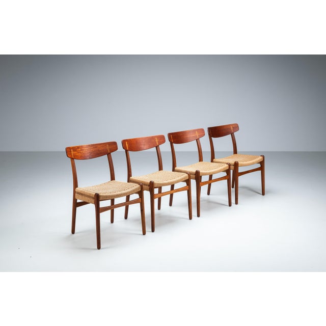 This set of four vintage ch23 dining chairs by hans j. Wegner embodies the quiet mastery of danish modern design—where...