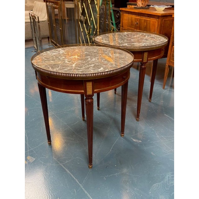 The product is a set of two 19th Century French Directoire Mahogany Boulliotte Tables, exuding a classic elegance. Made...