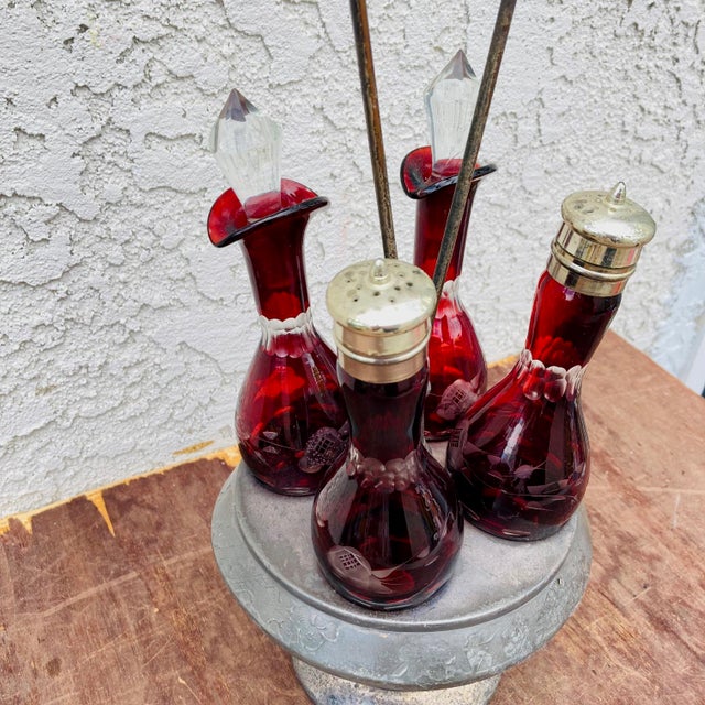 This is a most delightful late 1800s / early 1900s cruet set in Ruby etched glassed with a silver plated rotating...