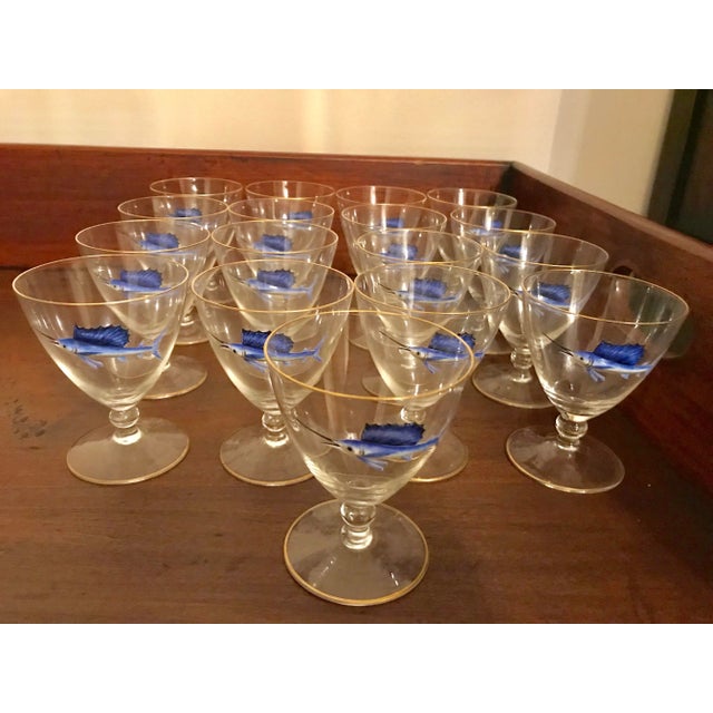 An awesome and unusual set of 17 hand blown crystal Art Deco Sailfish cocktail glasses with raised, molded and hand...