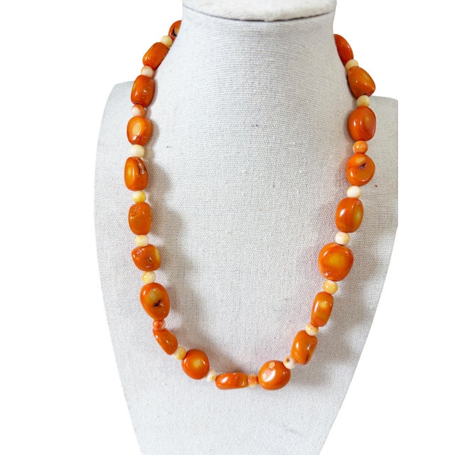 Vintage chunky natural coral necklace featuring polished, graduated beads in warm salmon and beige tones. Each bead...