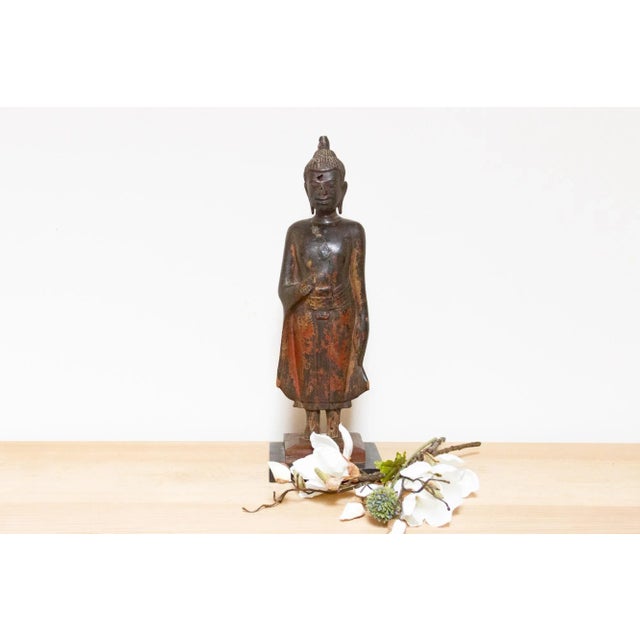 Wonderful antique Thai standing Buddha sculpture, a graceful masterpiece carved from wood. This exquisite piece captures...