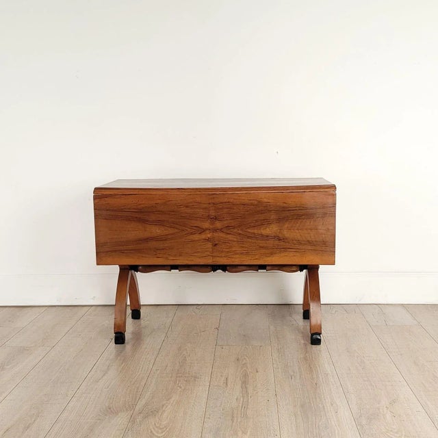 A rare and unusual Biedermeier dropleaf table with X supports at coffee table height with ebony trim, circa 1900. Width...