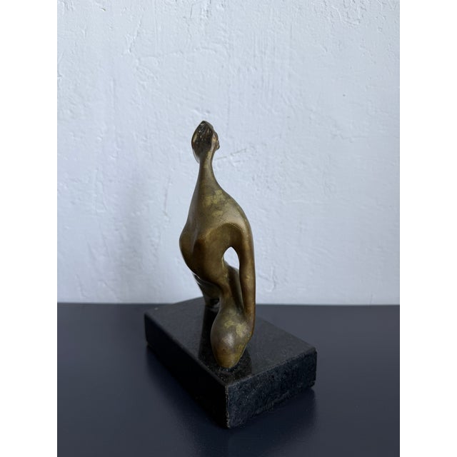 Patinated bronze modernist sculpture of female on granite base. Signed. Artist unknown.
