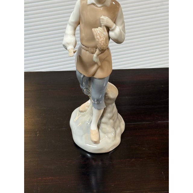 Design Plus Gallery presents the Porcelain Figurine Man with Geese by Miquel Requena for Lladró. The man in the figurine...