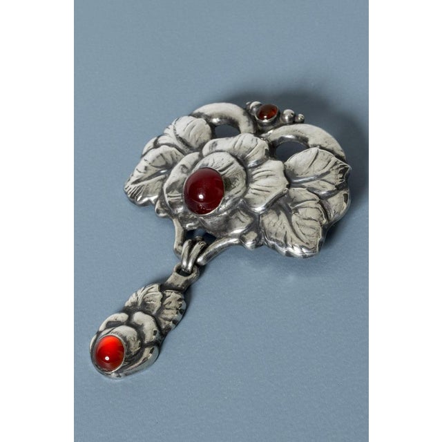 Beautiful Art Noveau silver brooch with garnet stones. Large size with two sections attached with a hoop. Deep red garnets...