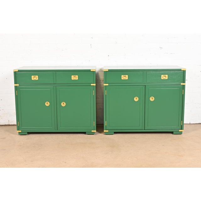 A sleek and stylish pair of mid-century modern Hollywood Regency Campaign style bar cabinets or buffet servers By...