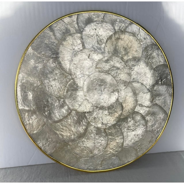 Set of 6 natural capiz shell round placemat chargers with brass rims and natural cork bottoms. Made by hand in the...