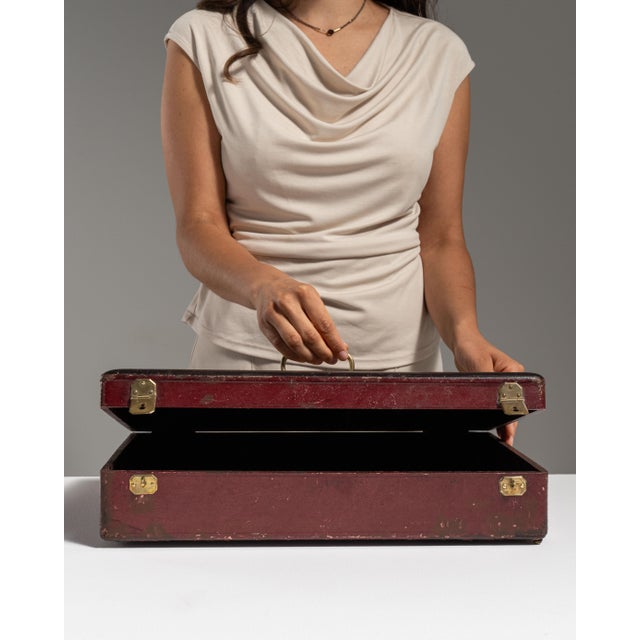 This early 20th century French silverware box from France is covered in deep burgundy-brown with brass clasps and a brass...