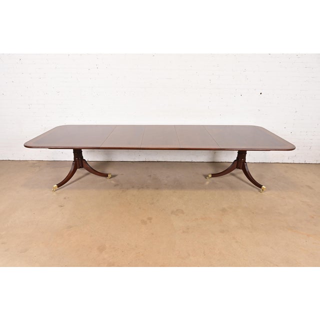 A rare and outstanding Georgian or Regency style double pedestal extension dining table By Baker Furniture, "Stately Homes...