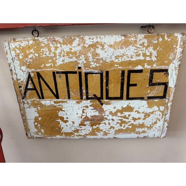 Charming vintage double-sided wooden trade sign, hand-painted with bold black ANTIQUES lettering against an aged ochre...