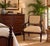 This Drexel Heritage arm chair features the classic Empire or Regency style. characterized by its elegant mahogany frame,...