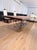 This Cattelan Italia dining table features a solid wood top with a natural edge and a unique grain pattern, giving it a...