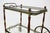 Rare neoclassical bar cart by Maison Baguès, France, 1940s. This Hollywood Regency piece features a refined brass frame...