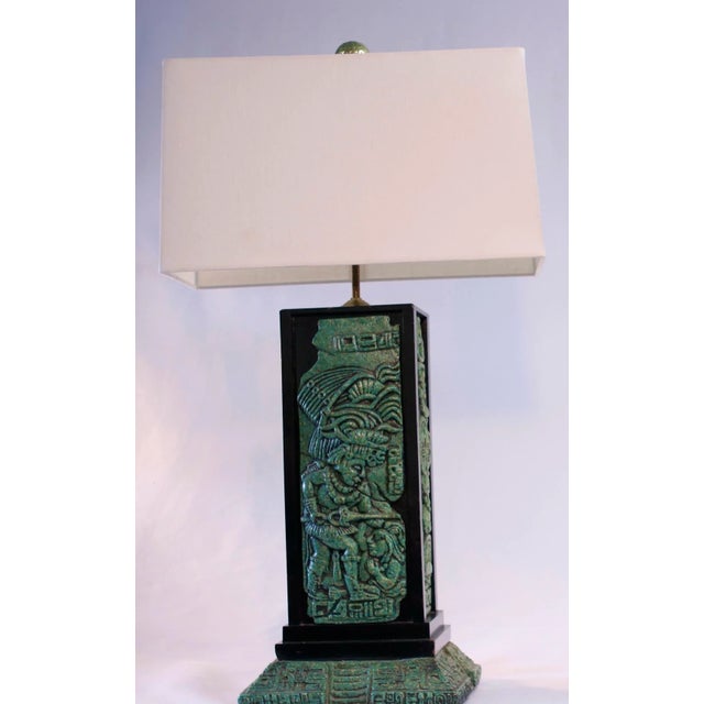 1960s era Mexican table lamp with a Mayan motif featuring a stepped up base. The lamp is made of mahogany wood and...