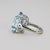 14k White gold rring with one rectangular aquamarine weighingapproximately 23.00 carats. 11.86 grams