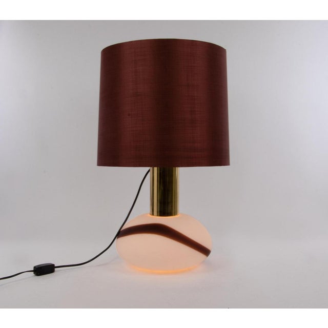 Elegant vintage design table lamp with white murano glass body with color accents on brass base. The light bulbs can be...