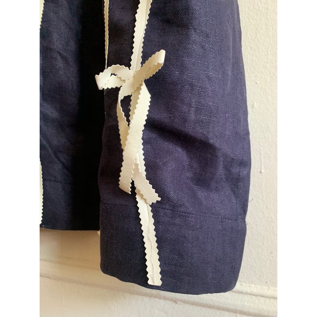 Handmade Sculpted Accent Panel on Heavy Linen The design includes white ribbons crafted from faux leather Top pocket for...