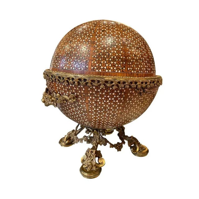 A spectacular 19th century mahogany circular inlaid liquor caddie. The caddie is inlaid throughout, and stands on four...