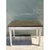 Exuding refined elegance, this vintage Neoclassical console table contrasts a dark polished stone top with a delicately...