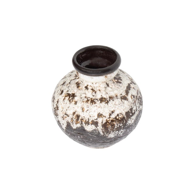 A West German fat lava vase produced by Dumler and Breiden. This vase features a round rim that tapers and then widens to...
