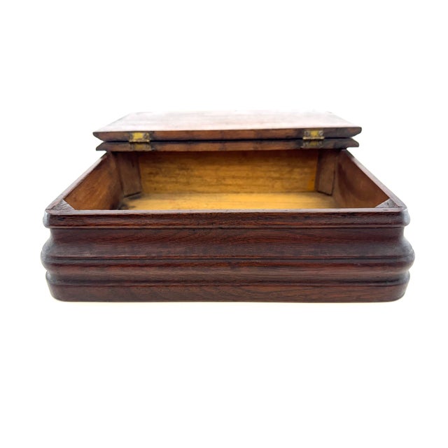 A handsome 19th-century wooden document box with a deep, timeworn finish and substantial molded profile. The rectangular...