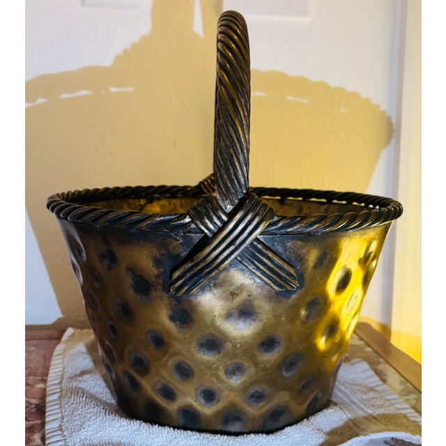 Brass basket with a marvelous faux rattan woven loop handle with cross laid ends, a woven rim and a round, sloped body...
