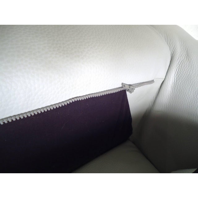 Mid-Century Modern white leather settee supported by a tubular chrome frame. Comfortable and stylish design ideal for both...