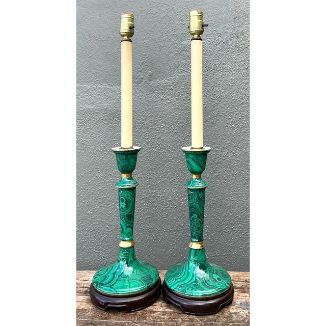 This pair of vintage candlestick table lamps is dressed in a bold faux malachite finish, with swirling concentric bands...