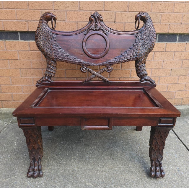 An early 20th Century Empire Style Heraldic coat of arms Intricately Carved Mahogany Double Eagle Bench with loose seat...