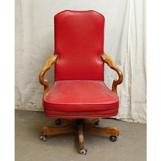 Features red studded vinyl with light wood tone arms & base. Made by Fairfield Chair Co. The manufacturer and exact date...