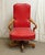 Features red studded vinyl with light wood tone arms & base. Made by Fairfield Chair Co. The manufacturer and exact date...
