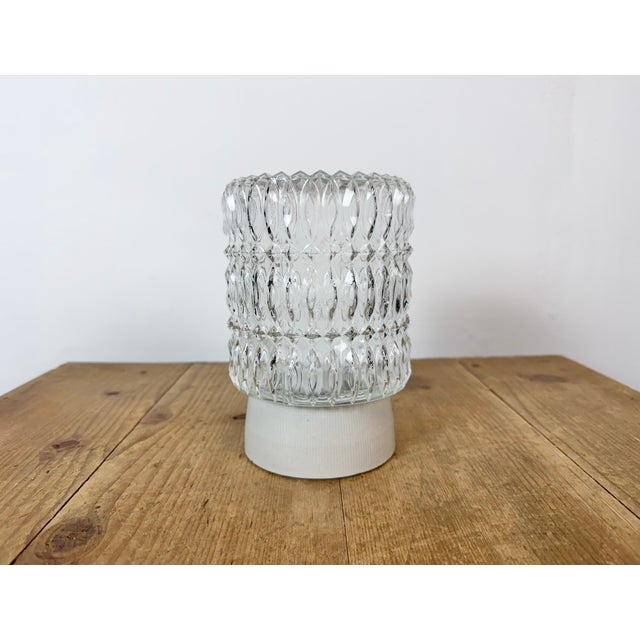 Vintage industrial ceiling or wall light made in former Czechoslivakia during the 1970s. It features a white porcelain...