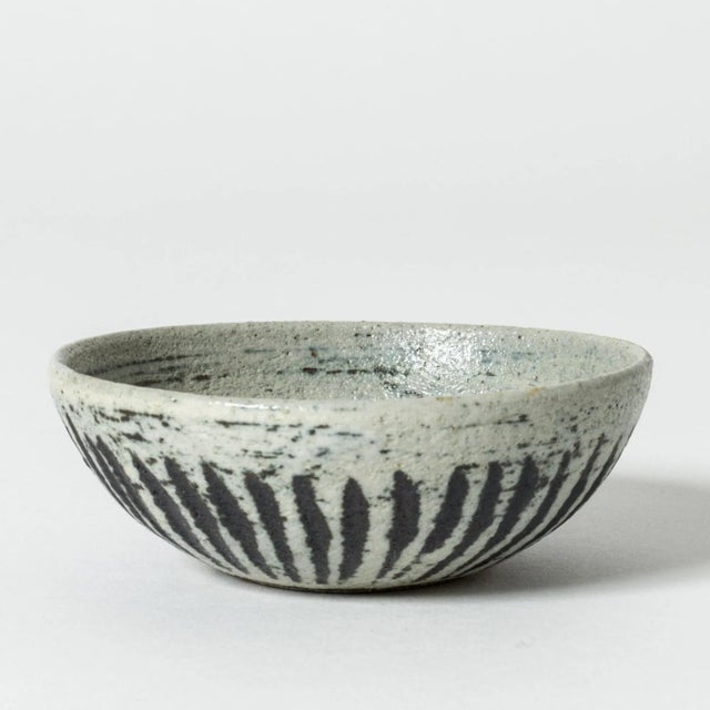 Miniature stoneware bowl by Anders B. Liljefors, with a structured, organic surface. Graphic pattern in blue and brown....