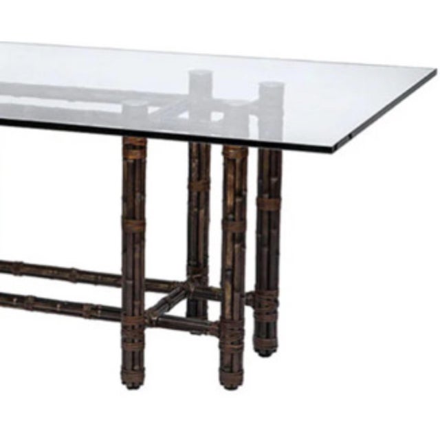 McGuire attributed bamboo dining table with beveled glass top. This classic table exudes an organic modern style. The...