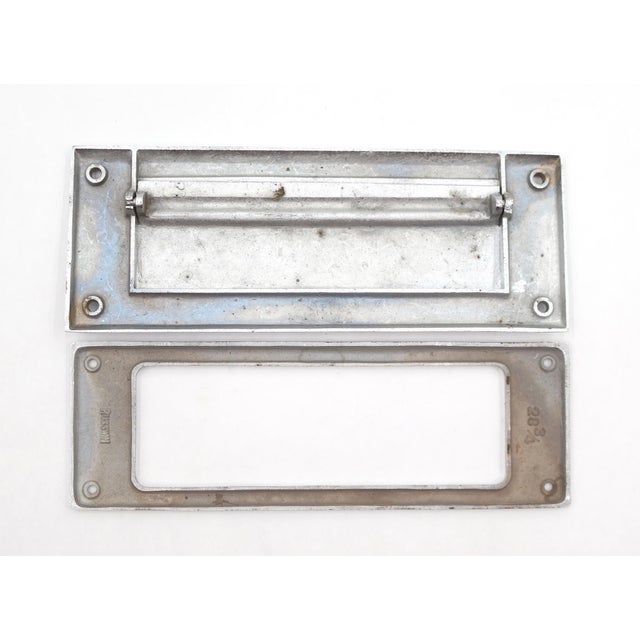 Vintage spring loaded mail slot that opens inward at 45 degrees to allow mail through. Made of brass with a chrome finish....