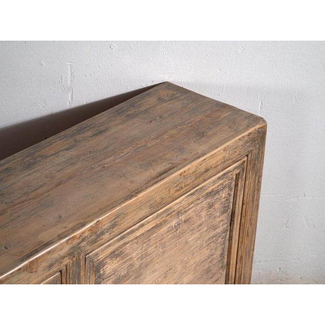 Large chinese sideboard in solid pine, with two doors and two shelves inside decorated in subtle low relief, originally...