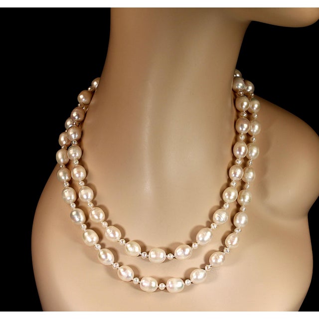 This exquisite two‑strand white freshwater pearl necklace is a timeless celebration of elegance and refinement. Designed...