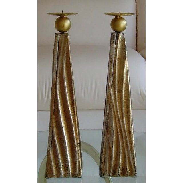 This contemporary candleholder set measure 20 inches tall by 4 inches wide at the bottom of each side, and the narrowest...