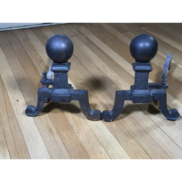 A pair of vintage Federal style brass andirons with ball tops, matching log stops and slipper feet. No maker’s mark....