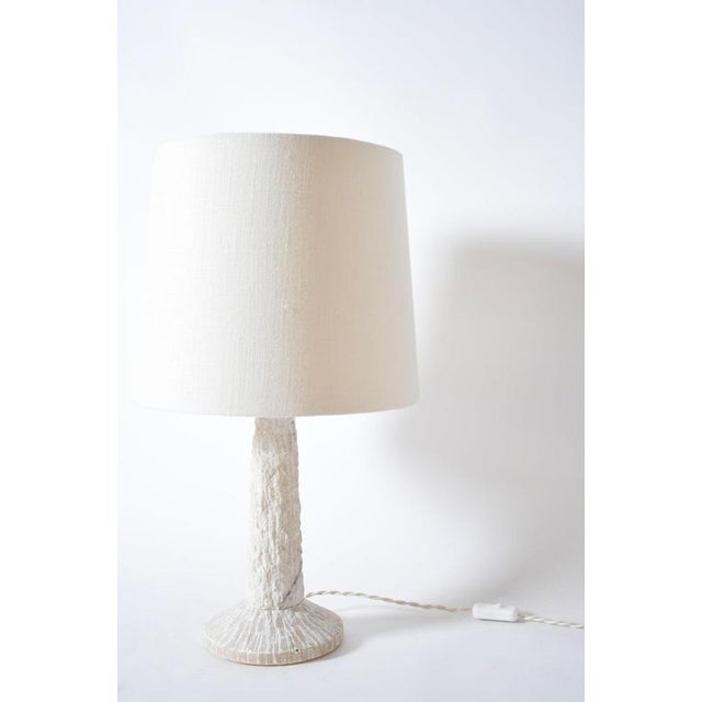 Brutalist alabaster table lamp, 1960s. Brutalist carved alabaster table lamp with a conic shape on a circular base. Italy,...