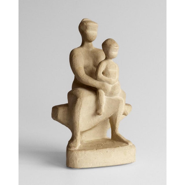 Evocative plaster sculpture depicting a seated mother cradling her child, crafted in the 1950s/60s by prominent Swedish...