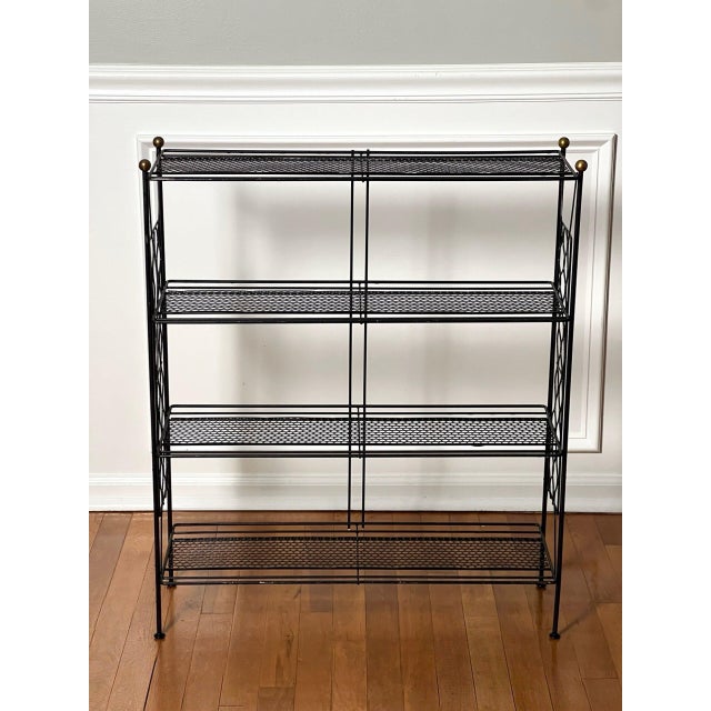 Tony Paul style vintage mid-century modern black metal four-tier etagere, 1960s. A sculptural etagere with a chic,...
