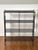 Tony Paul style vintage mid-century modern black metal four-tier etagere, 1960s. A sculptural etagere with a chic,...