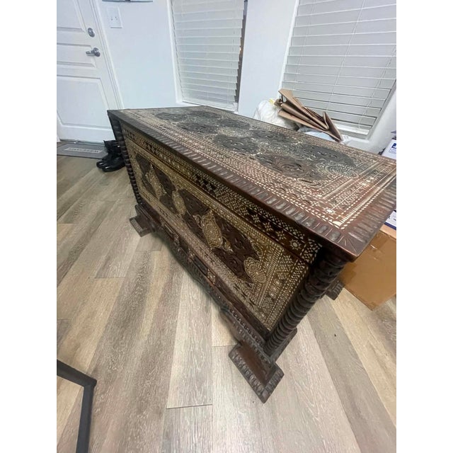 Magnificent vintage Syrian-style storage chest featuring extensive hand-carved woodwork and intricate mother-of-pearl...
